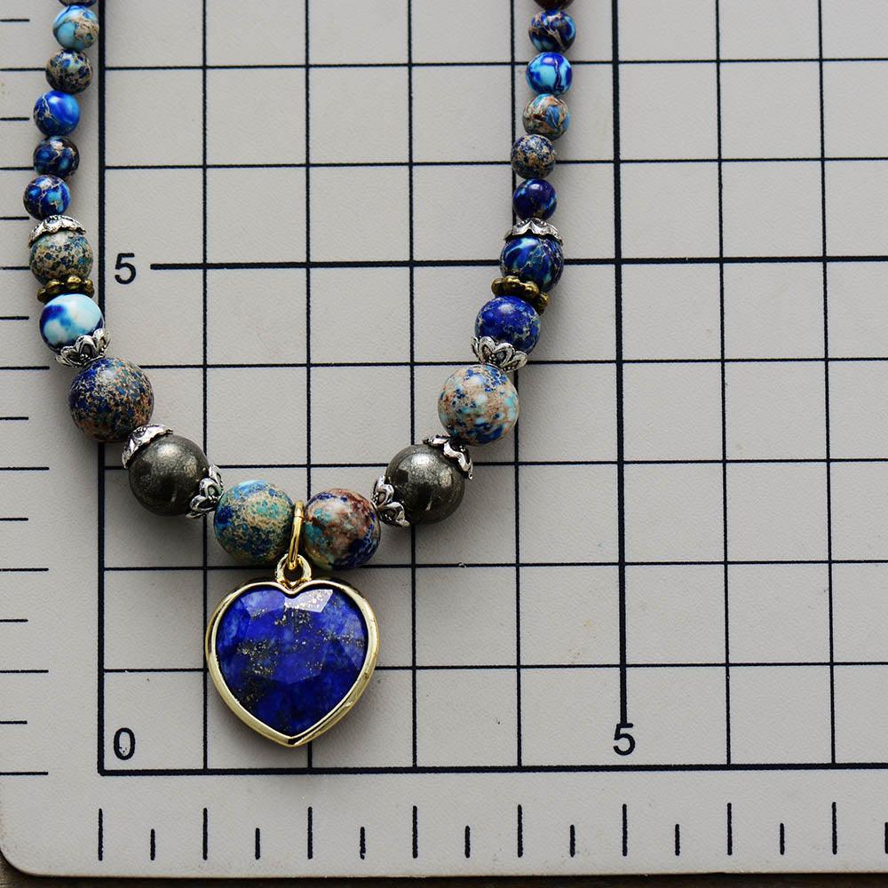 Close up of Jasper & Lapis Lazuli Heart Charm Wrap Bracelet–Necklace on size chart showing detailed bead mix and blue heart pendant. ALLORA JADE