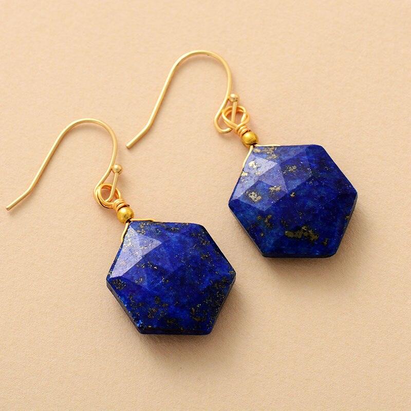 Close-up of Hexagonal Lapis Lazuli gemstone earrings with gold hooks. - ALLORA JADE