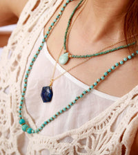 Woman wearing layered turquoise beaded necklace with crystal pendants- Allora Jade
