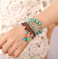 Turquoise wrap bracelet stacked with bohemian beaded bracelets on wrist - Allora Jade
