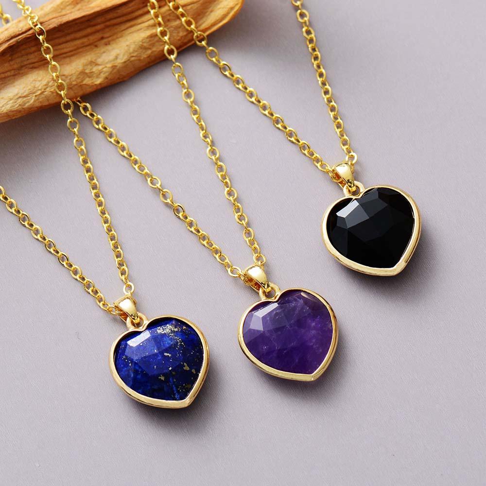 Heart pendant necklaces made with lapis Lazuli, Amethyst and Black Onyx, laying flat on grey background. ALLORA JADE