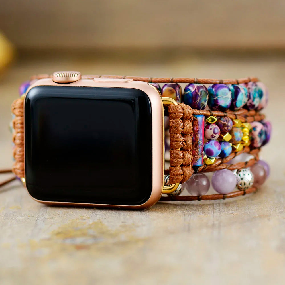 Smartwatch with a colorful beaded strap on a textured surface
