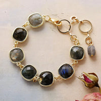 Gold bracelet with Labradorite stones on a light background