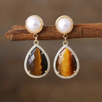 Tiger's Eye Pavé Teardrop Dangle Earrings featuring golden-brown banded gemstone drops framed by sparkling rhinestones, with imitation pearl studs in gold-coloured settings.