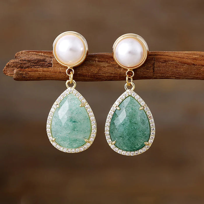 Green Quartz Pavé Teardrop Dangle Earrings featuring green gemstone drops framed by sparkling rhinestones, with imitation pearl studs in gold-coloured settings.