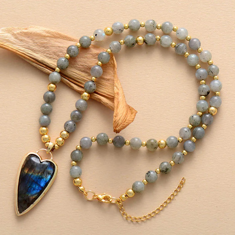 Beaded necklace with a heart-shaped pendant on a beige background