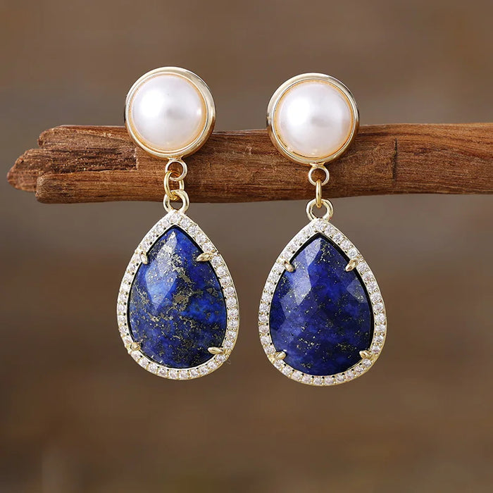 Lapis Lazuli Pavé Teardrop Dangle Earrings featuring deep blue gemstone drops framed by sparkling rhinestones, with imitation pearl studs in gold-coloured settings.