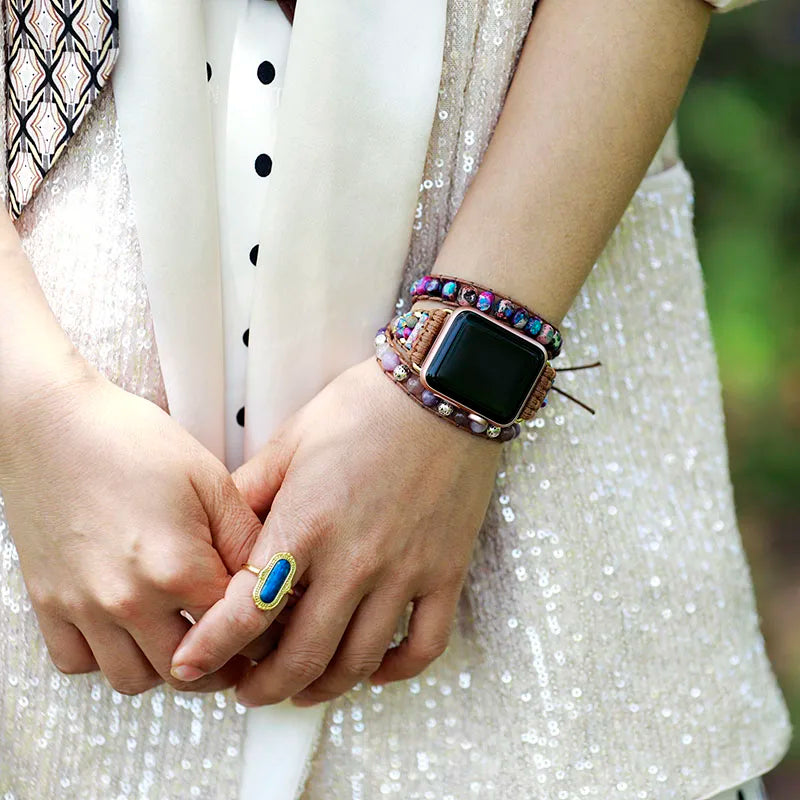 Close-up of a person's wrist wearing a colorful smartwatch band with a blurred background