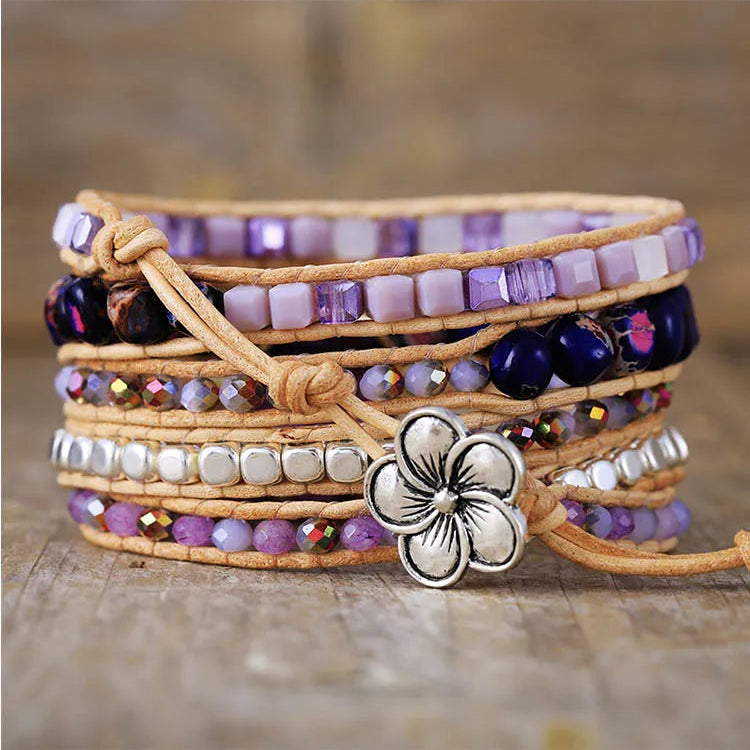 Multistrand beaded bracelet with purple beads and a silver-coloured flower button clasp.
