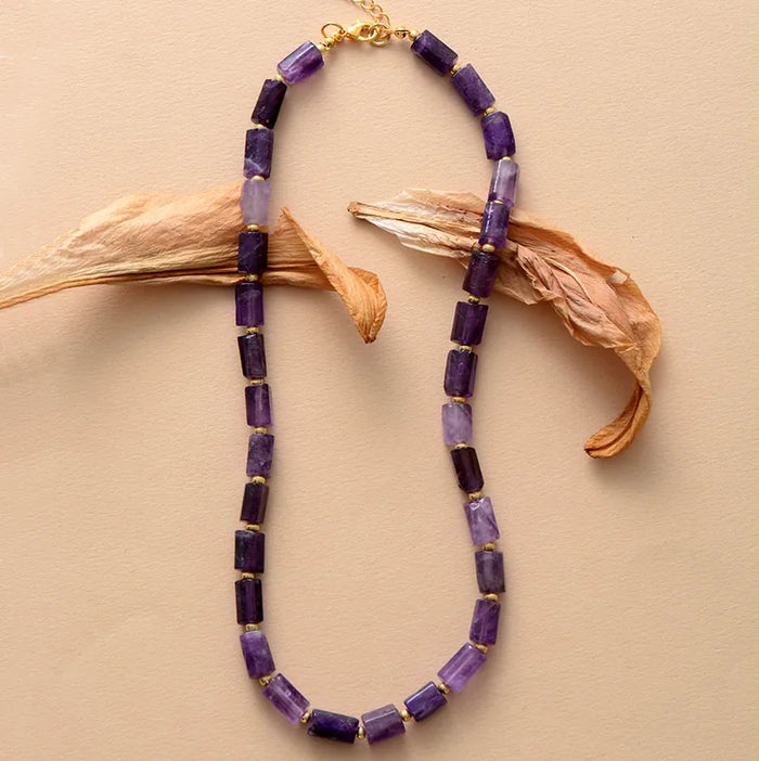 Purple beaded Amethyst Choker necklace with gold accents on a beige background - ALLORA JADE