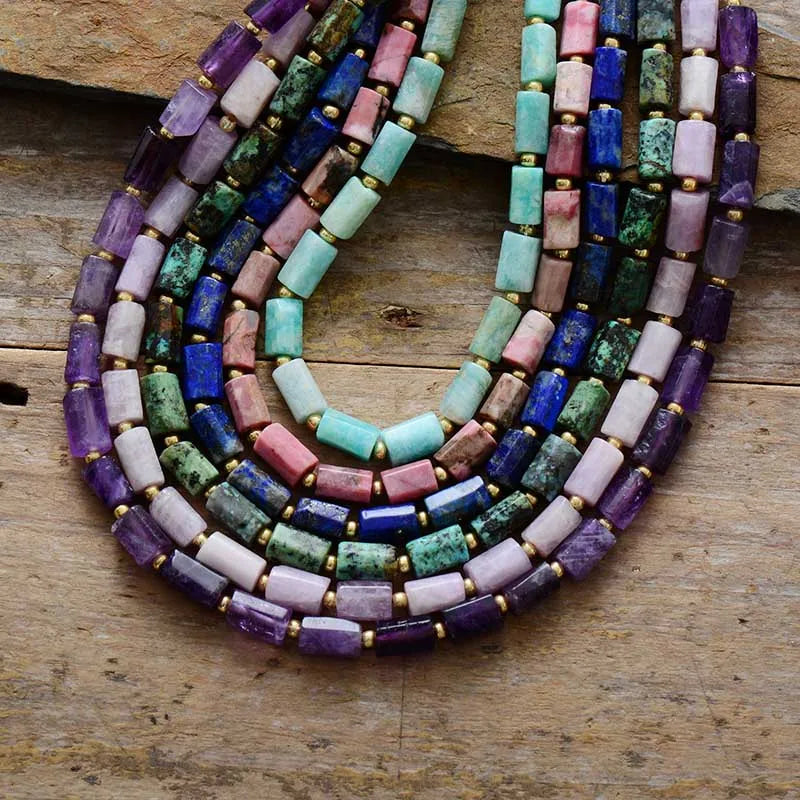 Colorful beaded necklace on a wooden surface. ALORA JADE