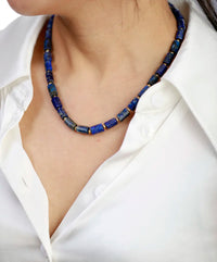 Person wearing a blue beaded necklace with a white shirt. ALLORA JADE